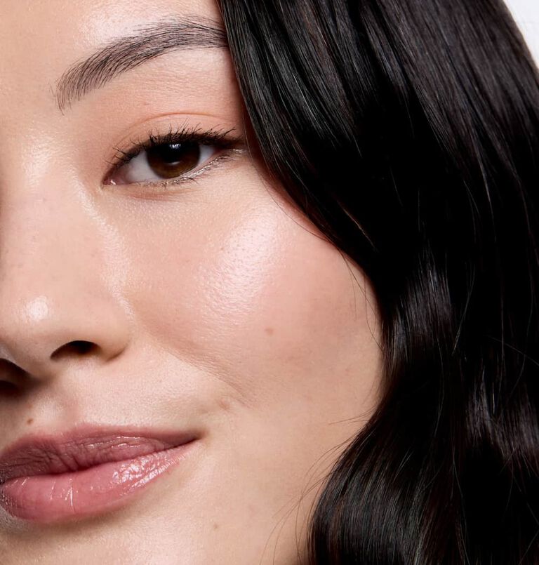 Woman smiling at the camera with radiant skin