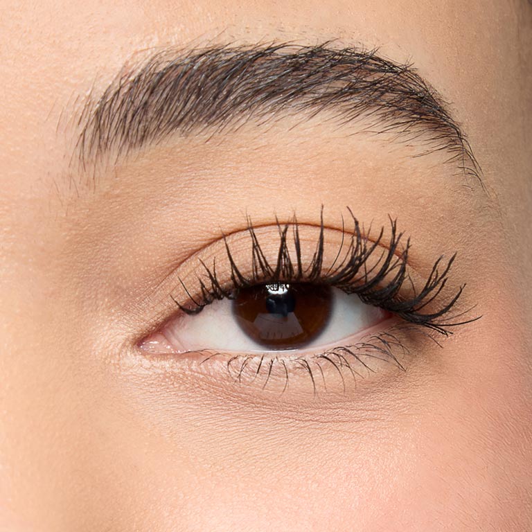 Close up of woman's eye with mascara on, showing longer lashes